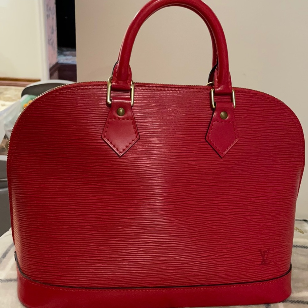 Authentic Louis Vuitton Alma PM red leather satchel.